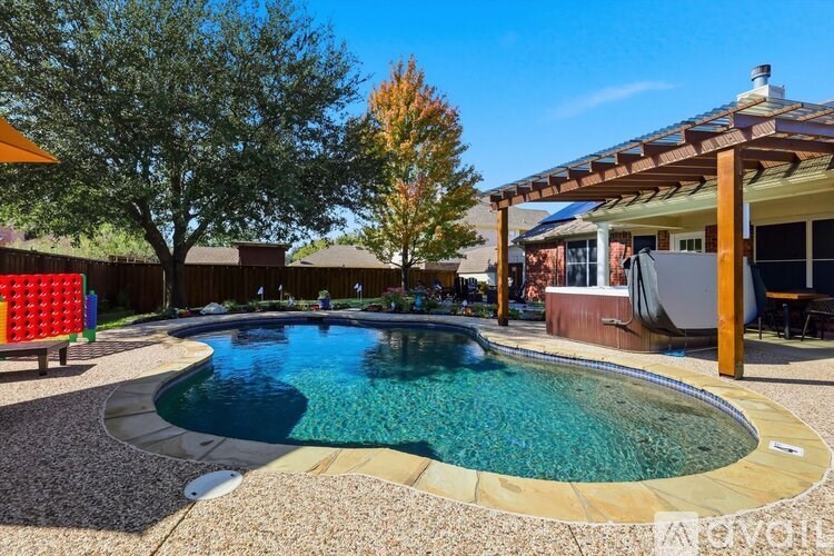 A small pool with a wooden deck and a pergola.