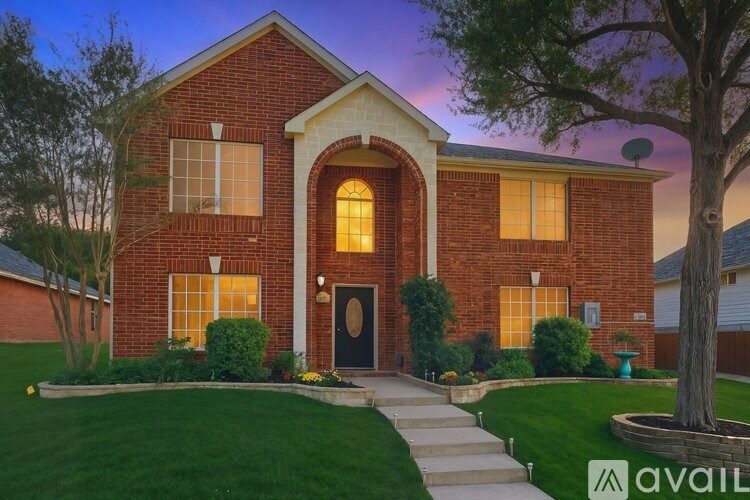 A house with a brick facade and a large front yard.