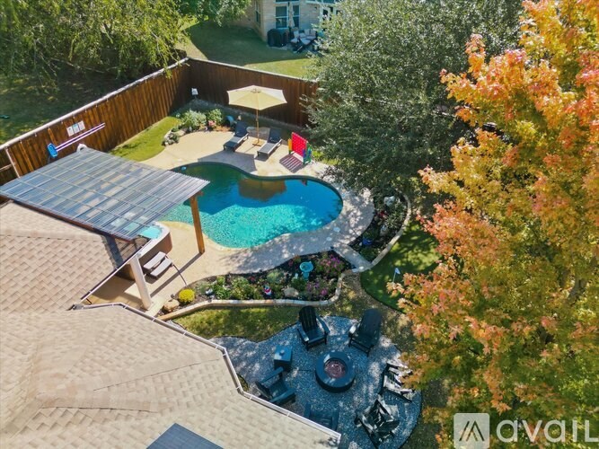 A backyard with a pool and a hot tub.