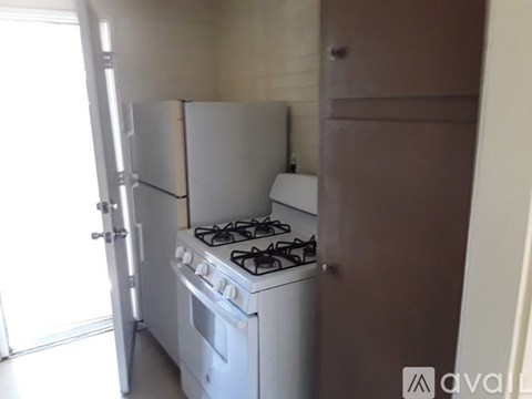 A white stove and fridge in a kitchen.