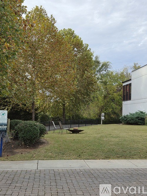 A park with a bench and trees.