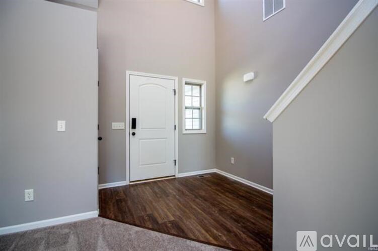 A room with a white door and a window.