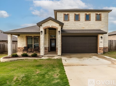 A house with a garage and a driveway in front.