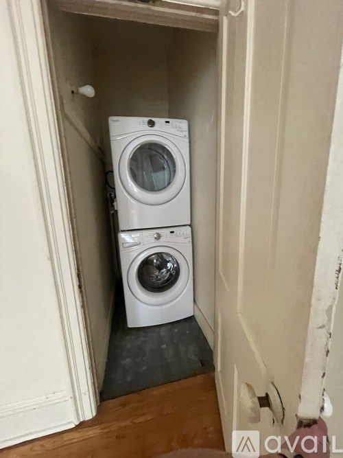 A white washing machine is in a small alcove.