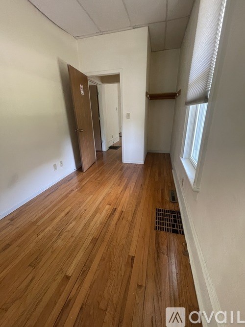 A room with wooden floors and white walls.
