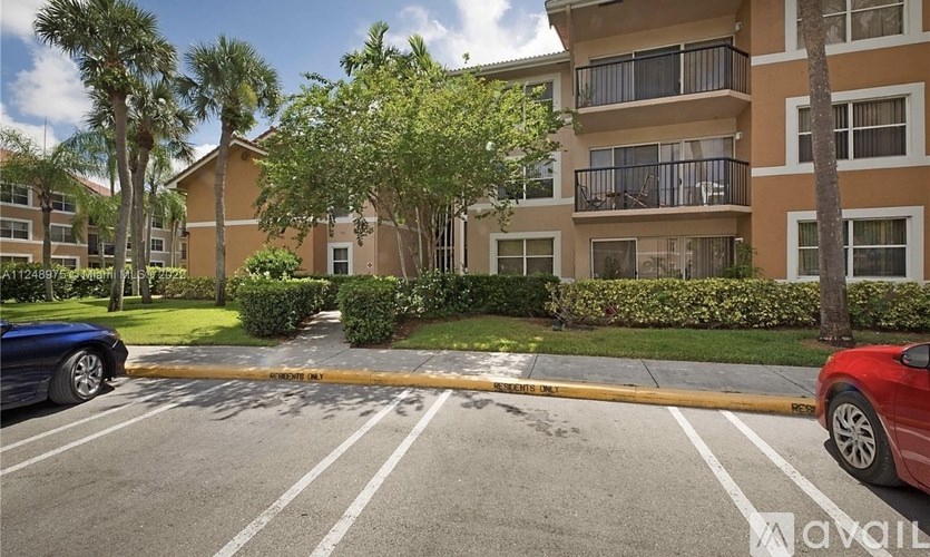 A parking lot with a blue car on the left and a red car on the right.