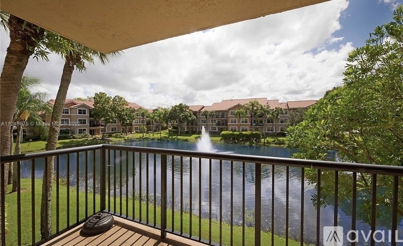 A balcony overlooks a pool and a resort.