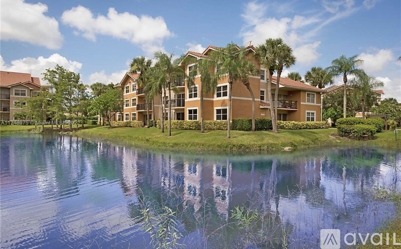 A large building with a pond in front of it.