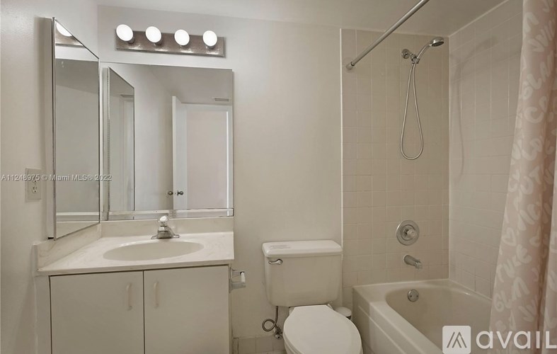 A bathroom with a sink, toilet, and bathtub.