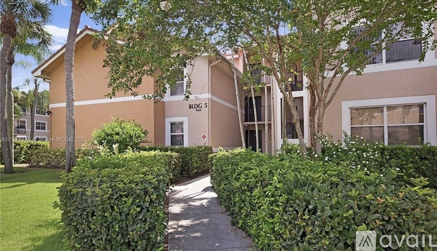 A building with the number 5 on it is surrounded by greenery.