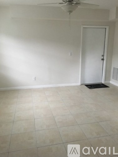 A room with a fan and a door.