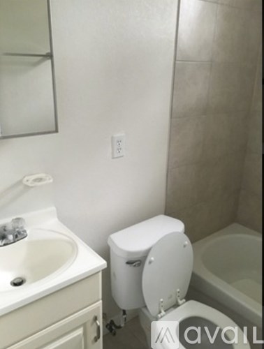 A white toilet is next to a sink in a bathroom.