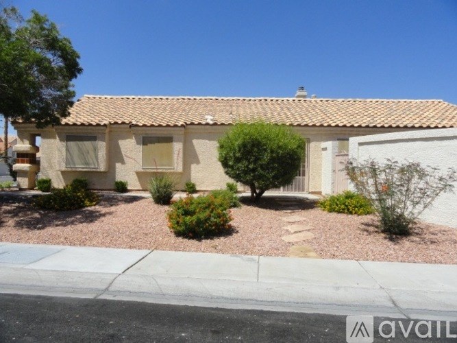 A house with a red tile roof and a white garage door.