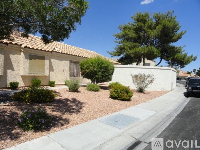 A house with a garden in front of it.