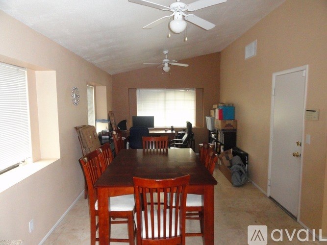 A dining room with a wooden table and chairs.