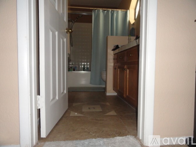 A room with a white door and a rug on the floor.