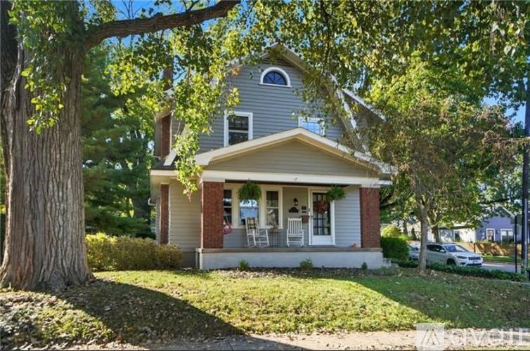 A house with a tree in front of it.