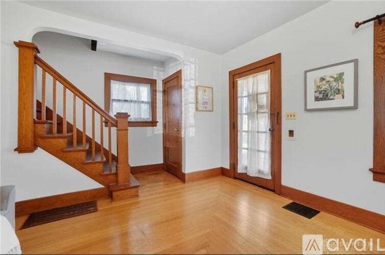 A living room with a staircase and a door.