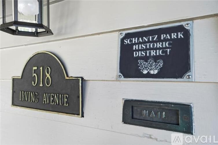 A Schantz Park Historic District sign is on a white wall.