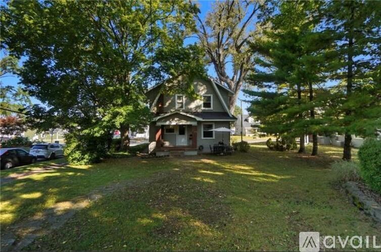 A house with a large front yard is for sale.