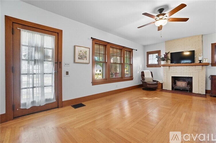 A living room with a fireplace and a television.