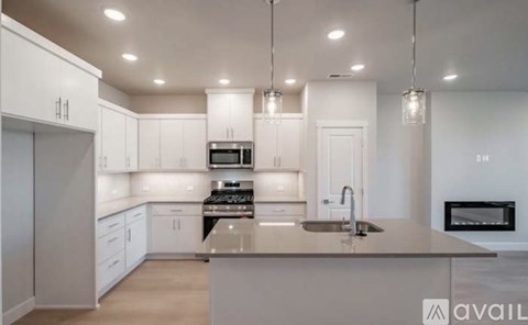 A modern kitchen with white cabinets and a central island.
