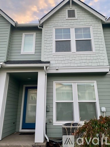 A house with a blue door and a white column.
