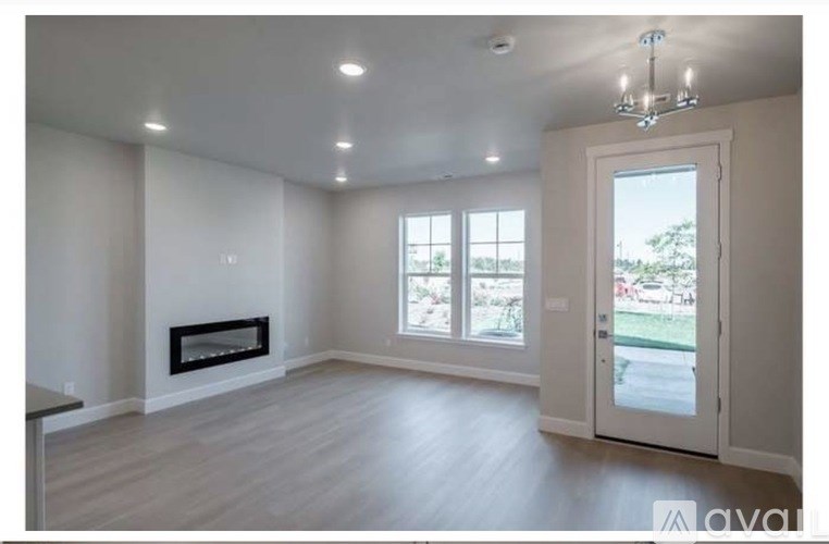A room with a white door and a carpeted floor.