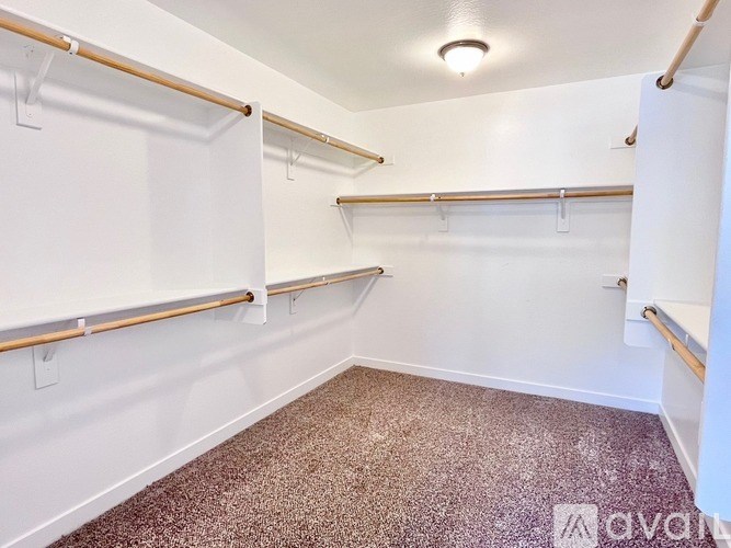 A room with a carpeted floor and white walls.