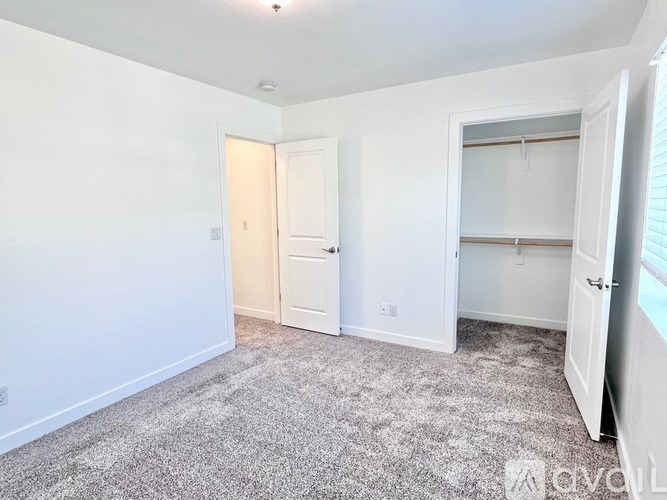 A room with a carpeted floor and a door.