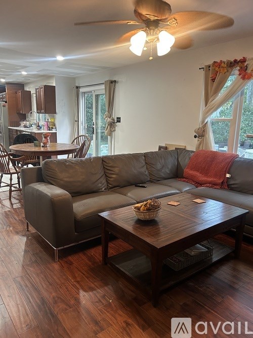 A living room with a grey couch and a wooden coffee table.