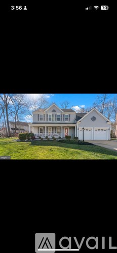 A house with a white garage door and a red door is shown.