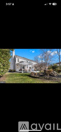 A house with a white exterior and a large front yard.