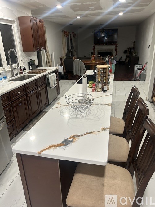A kitchen with brown cabinets and a white counter top.