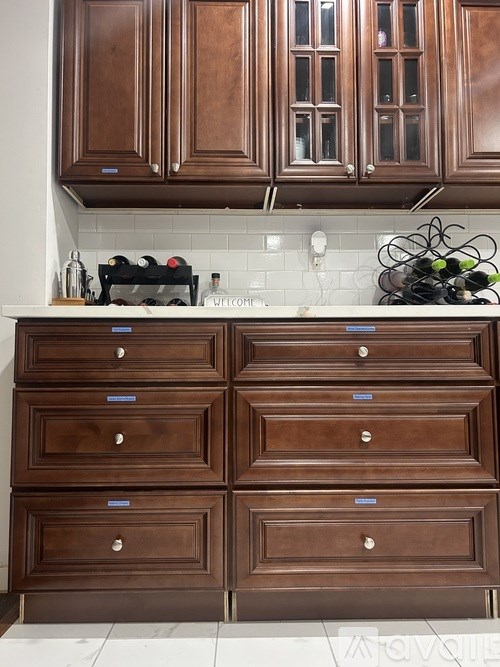 Brown wooden drawers and cabinets in a kitchen.