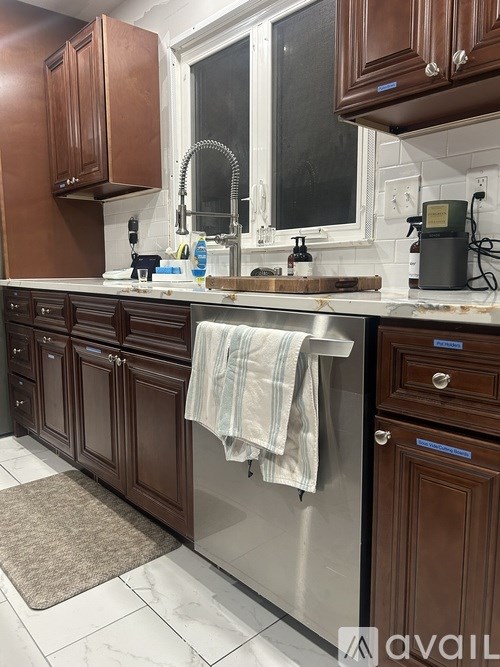 A kitchen with brown cabinets and a white counter top.