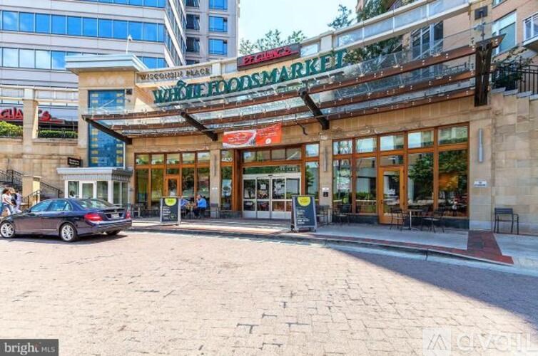 A Whole Foods Market is located in a building with a large glass facade.