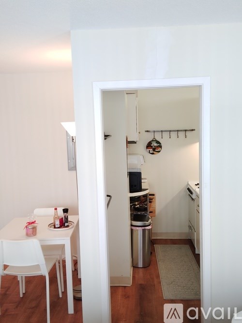 A small kitchen with a table and chairs in a room.