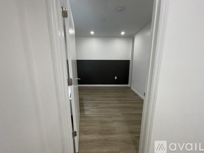 A room with a wooden floor and white walls.