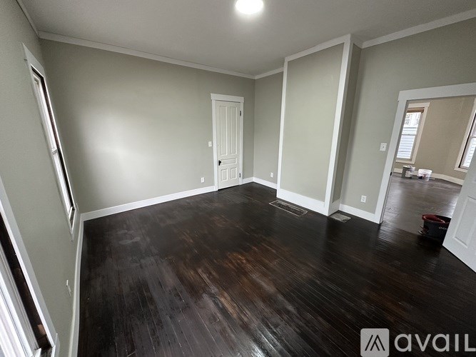 A room with wooden floors and white walls.