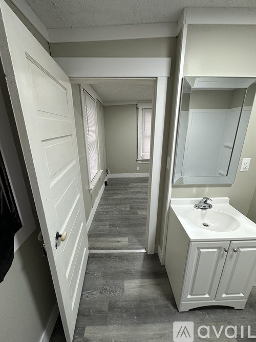 A bathroom with a sink and a mirror.