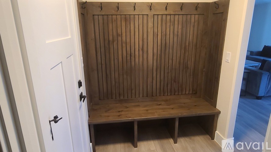 A wooden bench with a door on the left side.