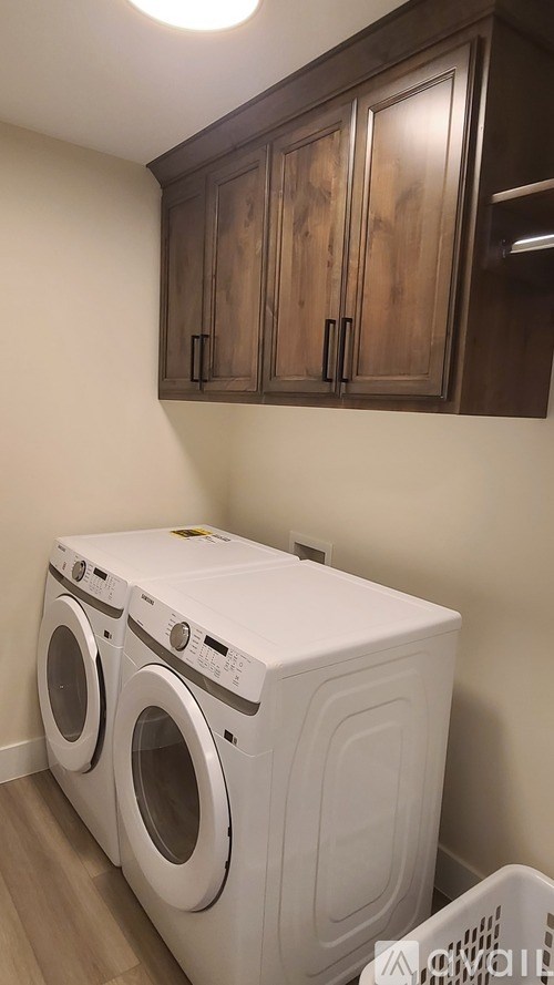 A small laundry room with a washer and dryer.