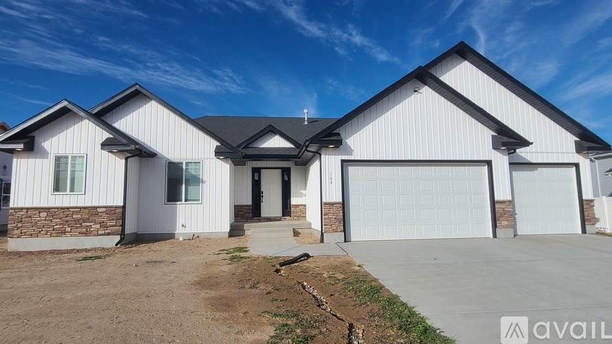 A modern house with a white exterior and a large garage door.