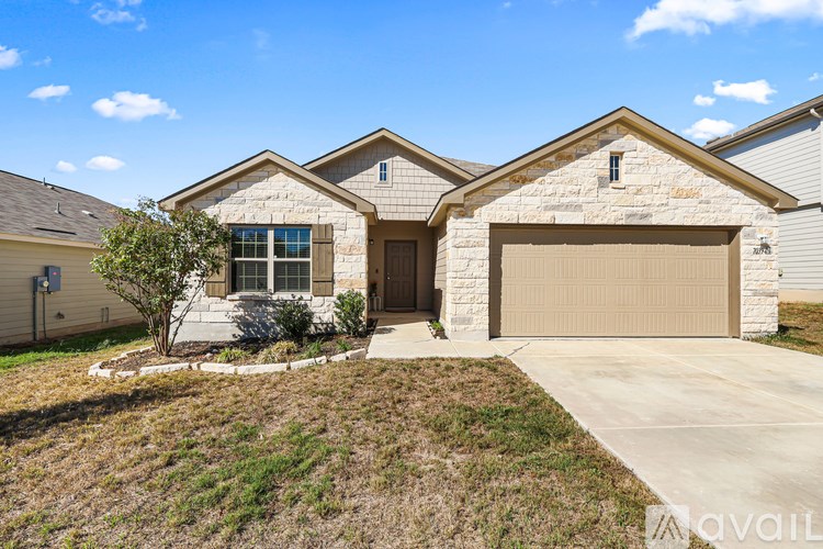 A house with a garage and a driveway in front.