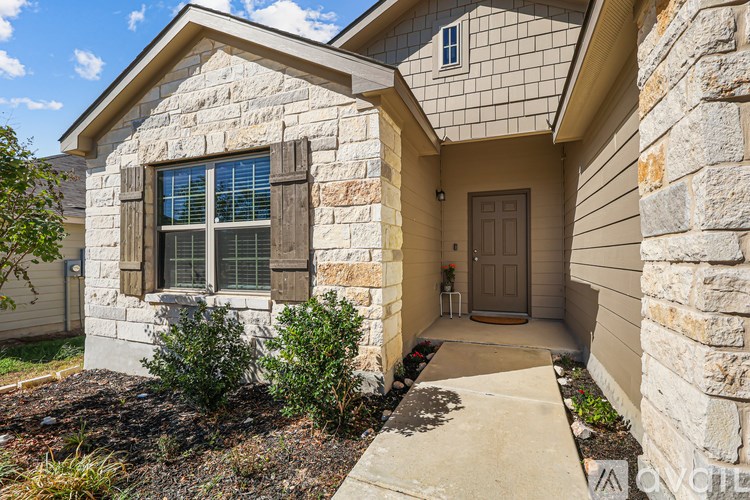 A house with a stone exterior and a brown door.