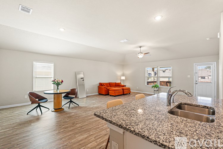 A kitchen with a granite countertop and a sink.