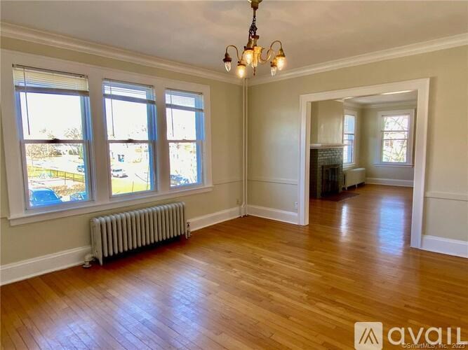 A room with wooden floors and a chandelier.