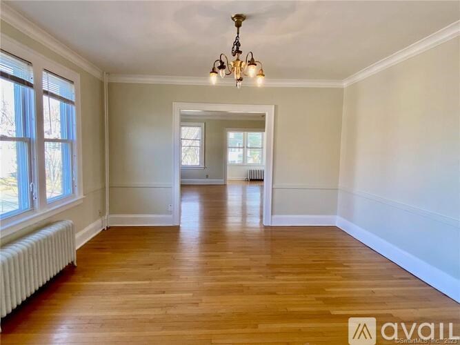 A room with wooden floors and a chandelier.