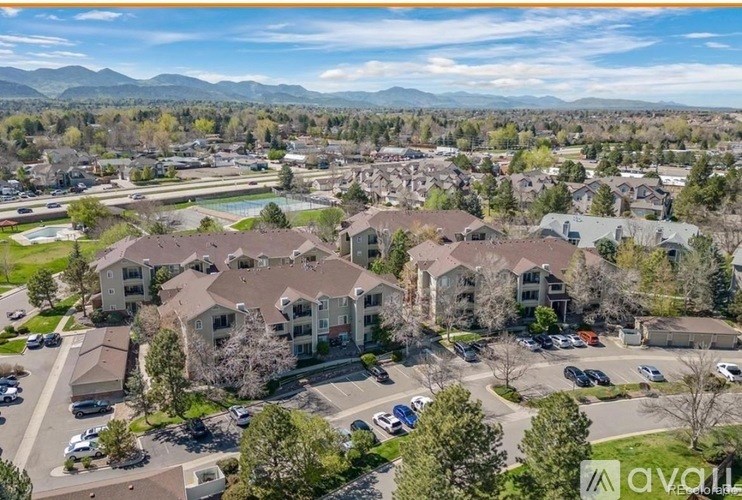 A bird's eye view of a residential area with houses and cars.